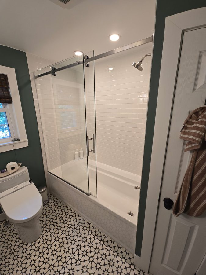 Frameless corner shower enclosure