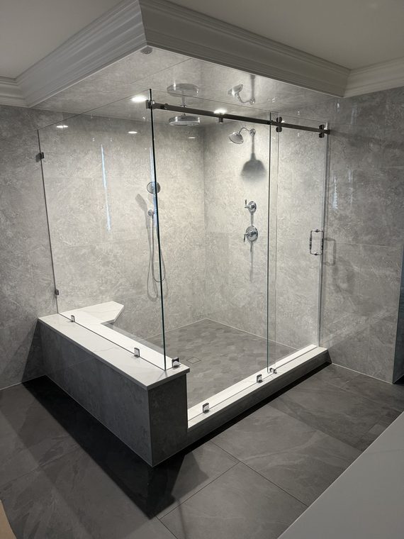Frameless glass shower enclosure