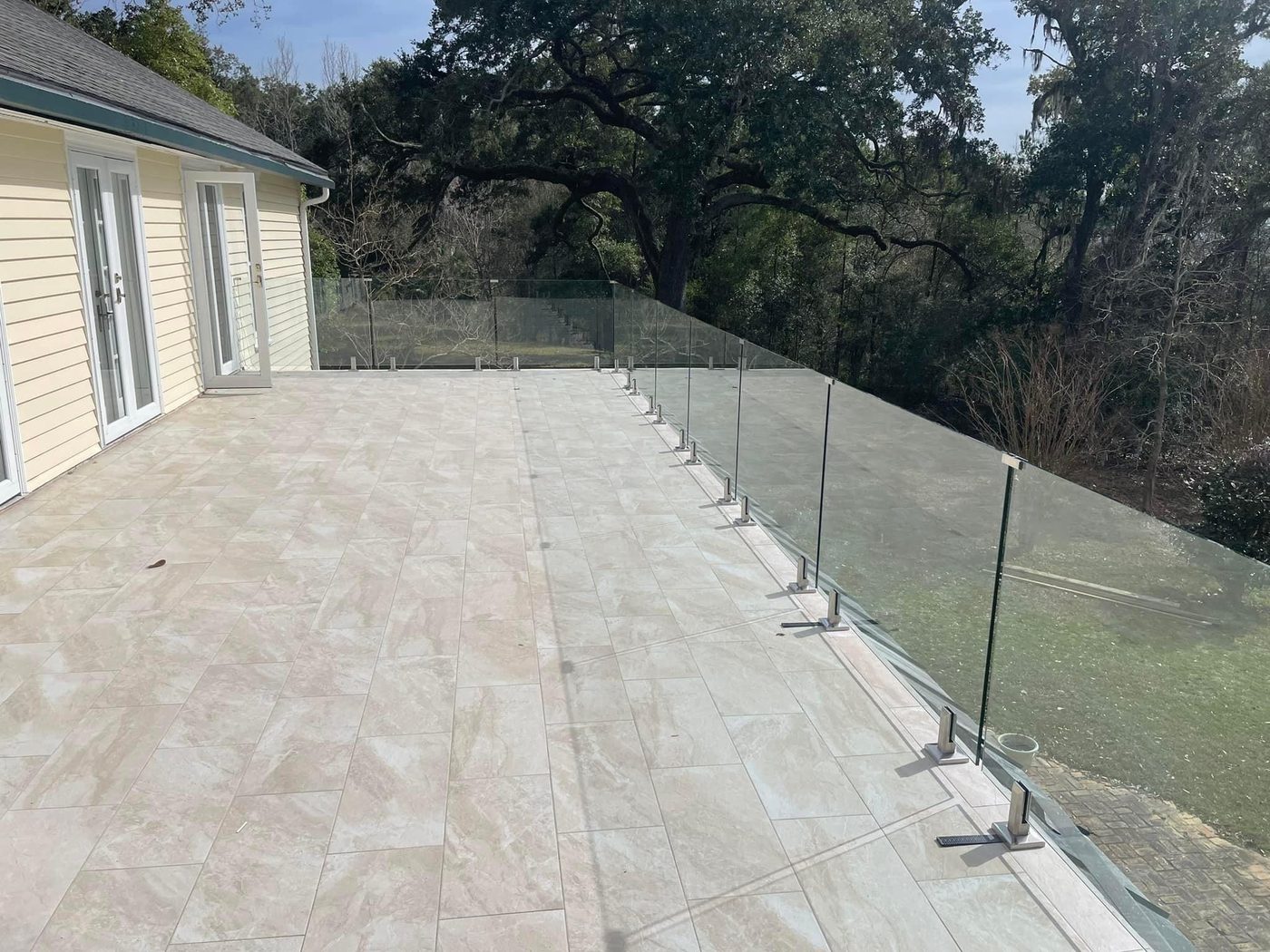 Frameless glass deck railing with stainless spigot posts